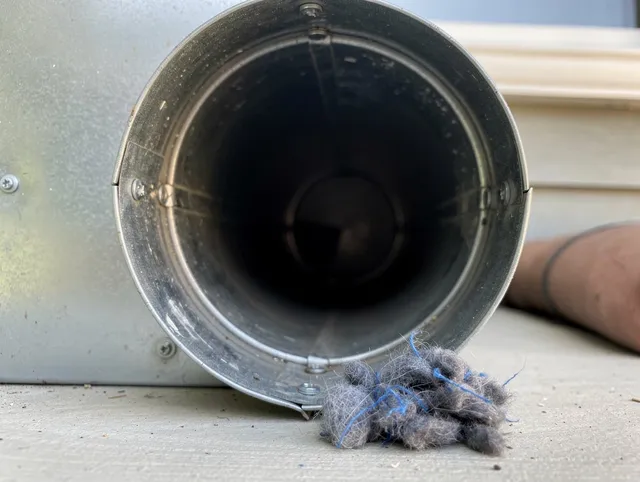 Stafford Dryer Vent Cleaning technician using specialized equipment to clear severe dryer vent blockage in Stafford